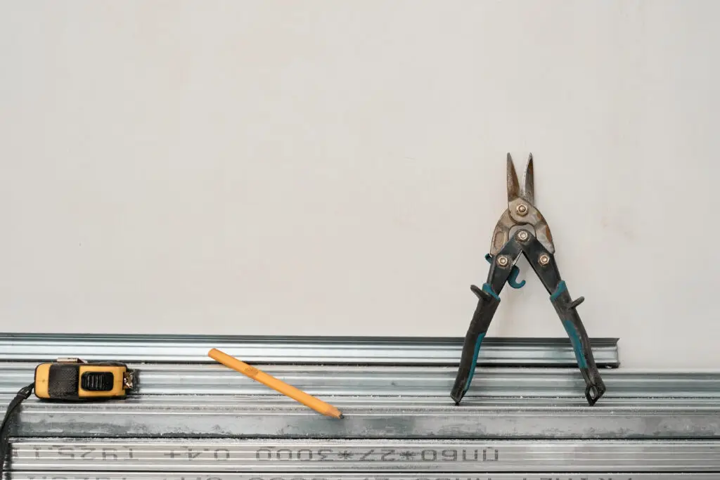 What Are The Different Types Of House Siding? 2 Metal Profiles Drywall Laid Floor Against Wall Tape Measure Metal Scissors Preparing Profiles Installation Wall Ceiling Frame